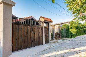 a wooden fence in front of a house at The Red Roof House in Plovdiv