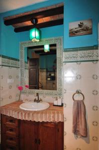 a bathroom with a sink and a mirror at `PRECIOSA CASA ANDALUZA CON VISTAS in San Roque +17 photos