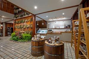 a bar with two wooden barrels in a room at Khaokhoherbary OrganicFarm&Resort in Khao Kho