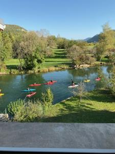 a group of people in kayaks on a river at Gite La Bastide in Ornans