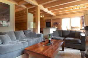 a living room with a couch and a table at Chalet Talini in Les Gets