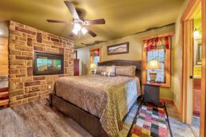 a bedroom with a bed and a stone wall at A Breath of Fresh Air chalet in Gatlinburg