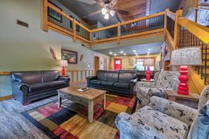 a living room with couches and a table at A Breath of Fresh Air chalet in Gatlinburg