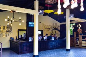 a restaurant with people sitting at a bar at Mad Monkey Luang Prabang in Luang Prabang