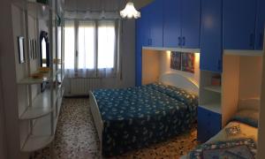 a bedroom with blue cabinets and a bed in it at Holiday Villas in Marina di Massa