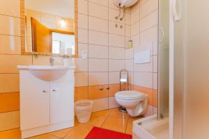 a bathroom with a sink and a toilet at Apartmani Villa Marija in Omiš +195 photos