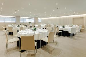 a conference room with white tables and chairs at Hesperia A Coruña Centro in A Coruña