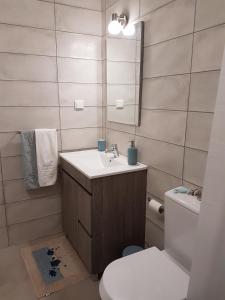 a bathroom with a sink and a toilet and a mirror at Monte da Caldeirinha in Luz de Tavira