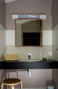 a bathroom with a sink and a mirror at L'Arbre à Pain in Altier