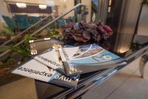 a glass table with pamphlets on top of it at Myo Hotel Wenceslas in Prague