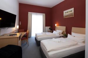 Postel nebo postele na pokoji v ubytování Hotel Mainpromenade ***S