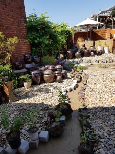 a group of pots and potted plants in a garden at The Hanok in Jeonju