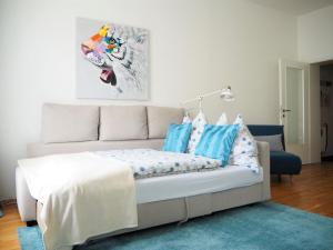 a bed with blue and white pillows in a room at APSTAY City Residence Apartments ǀ Parking option & Self Check-in in Graz