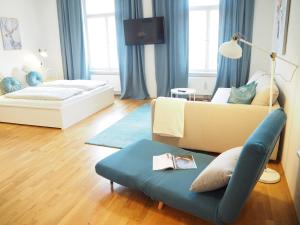 a living room with a couch and a chair at APSTAY City Residence Apartments ǀ Parking option & Self Check-in in Graz
