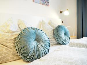 a bedroom with two blue pillows on a bed at City Residence Apartments FREE Parking & Self Check-in in Graz