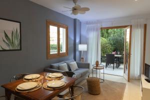 a living room with a couch and a table at APARTAMENTO EL ROJO in Can Picafort