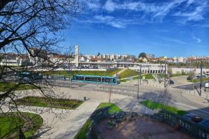 Un autobús azul conduciendo por una calle en una ciudad en Appartment Les Suites Du Parc en Besançon