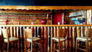 a bar with four stools in front of it at Le Terril Blanc in Tignes