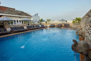 a swimming pool with an elephant in the middle of it at Buddy Lodge, Khaosan Road in Bangkok