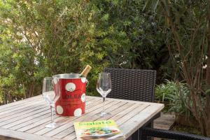 a table with two wine glasses and a bucket on it at EL ROJO 2 in Can Picafort +11 photos