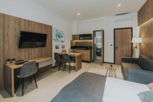 a living room with a bed and a couch and a kitchen at Apricot Luxe Apartments in Zagreb