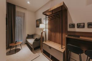 a living room with a tv and a couch and a chair at Apricot Luxe Apartments in Zagreb