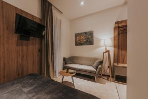 a hotel room with a bed and a couch at Apricot Luxe Apartments in Zagreb