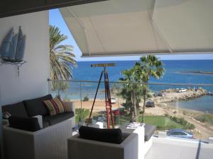 a living room with a view of the ocean at Trident Beach Apartment in Protaras