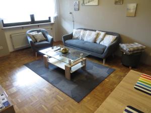 a living room with a couch and a coffee table at Ferienwohnung am Eck in Amorbach