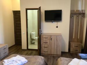 a hotel room with a television and a bedroom at Guest House MARGARYAN in Yerevan +55 photos
