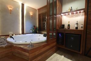 a large bathroom with a large tub in a room at Pousada Meu Talento in Alto Paraíso de Goiás +118 photos