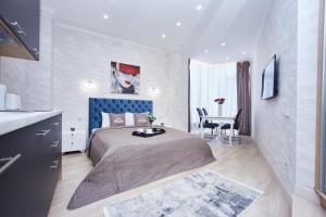 a bedroom with a bed and a table in it at Panoramic Plaza Apartments in Odesa +97 photos