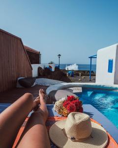 una mujer tendida en una toalla junto a una piscina en Villa Juan, en Las Puntas