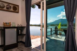a room with a view of the water from a house at Green View Resort in Vang Vieng