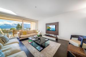 a living room with a couch and a table at Luxury Apartment Lake View & Center of Montreux by GuestLee in Montreux