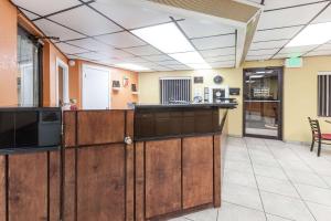 a lobby of a hospital with a counter and chairs at Super 8 by Wyndham Clinton in Clinton