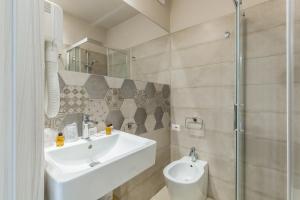 a bathroom with a sink and a toilet at Scicli Albergo Diffuso in Scicli