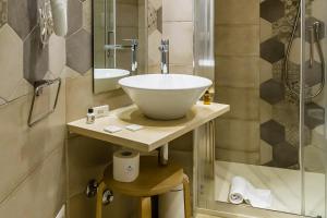 a bathroom with a sink and a shower at Scicli Albergo Diffuso in Scicli