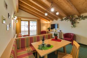 a restaurant with a table and red chairs at RAFFL APART in Sankt Anton am Arlberg