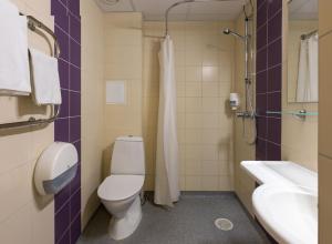 a bathroom with a toilet and a shower stall at Viiking Spa Hotel in Pärnu