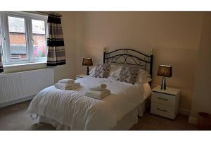 a bedroom with a bed with towels on it at Cooks Row in Scarborough