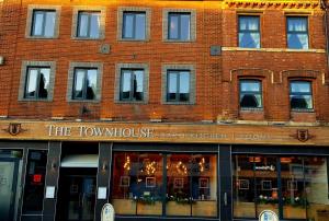 a red brick building with the town house and kitchen rooms at The Townhouse Boutique Hotel in Barrow in Furness