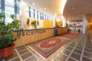 a reception area of a hospital with a rug on the floor at Hotel Bokan Exclusiv in Graz