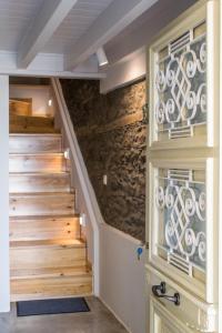 a staircase in a house with a stone wall at Anthi's House Center in Plomari