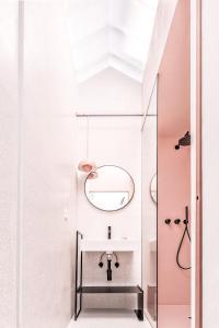 a bathroom with a sink and a mirror at Microcosmo La Spezia in La Spezia