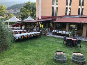 a restaurant with tables and chairs on the grass at Hotel River in Civitella Roveto