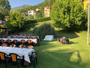 a group of tables and chairs in a yard at Hotel River in Civitella Roveto