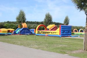 a water park with a colorful inflatable playground at Olmenduin No. 49 in Serooskerke