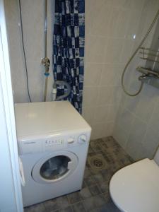 a bathroom with a washing machine and a toilet at Studio 1 Apartment Tampere in Tampere