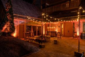 a patio with lights on the side of a building at Boutique hotel Vila Planinka in Zgornje Jezersko